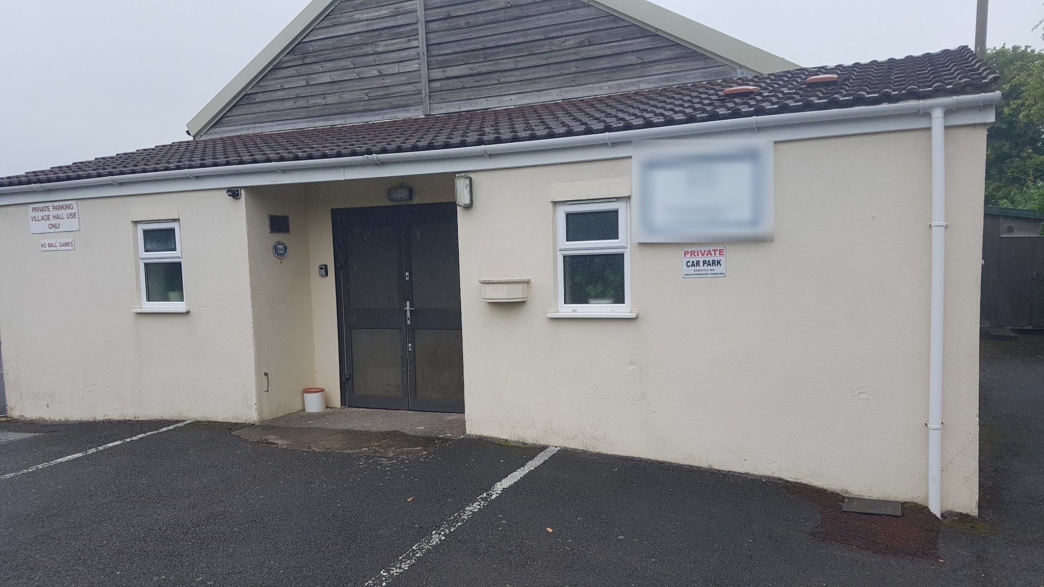 Village hall exterior with freshly painted cream render and white windows