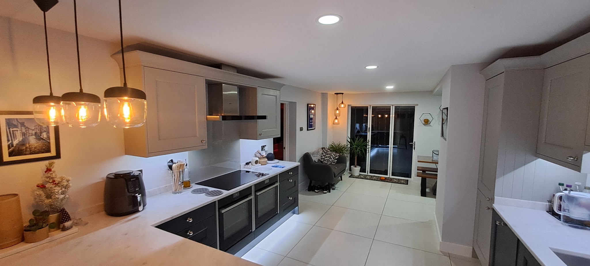 Finished open-plan kitchen with light grey walls